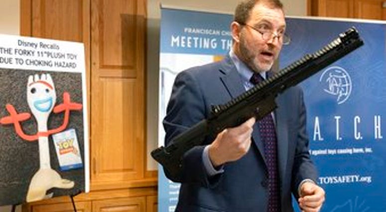 James Swartz, director of World Against Toys Causing Harm, holds a realistic toy machine gun during a news conference unveiling the organization's list of worst toys for the holidays, Tuesday, Nov. 19, 2019, in Boston. (AP Photo/Michael Dwyer)