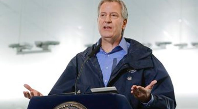 FILE - In this March 31, 2020 file photo, New York City Mayor Bill de Blasio speaks at the USTA Indoor Training Center where a 350-bed temporary hospital will be built in New York. (AP Photo/Frank Franklin II, File) FILE - In this March 31, 2020 file photo, New York City Mayor Bill de Blasio speaks at the USTA Indoor Training Center where a 350-bed temporary hospital will be built in New York. (AP Photo/Frank Franklin II, File)