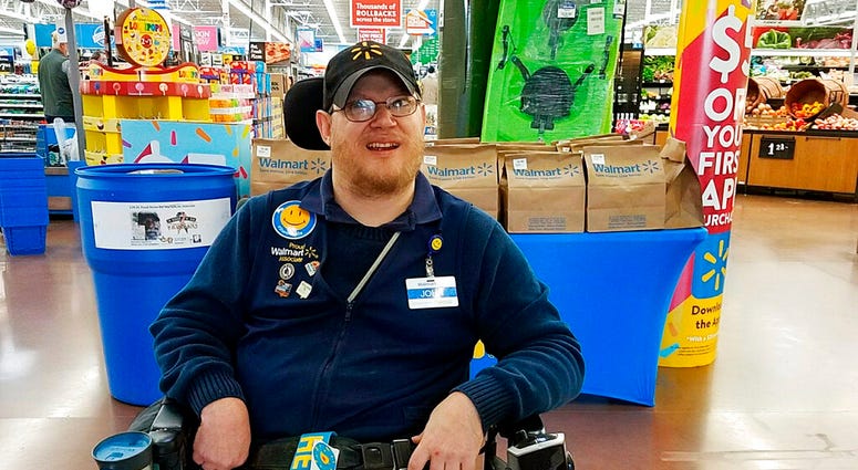 In this April 21, 2018 photo provided by Rachel Wasser, Walmart greeter John Combs works at a Walmart store. (Rachel Wasser via AP)
