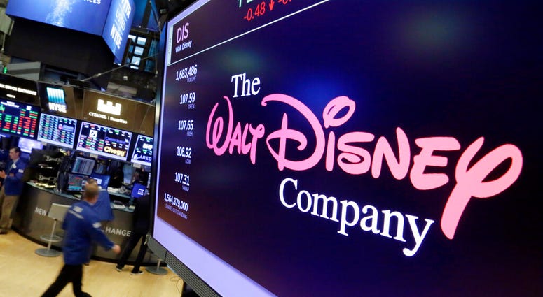 FILE - In this Aug. 8, 2017, file photo, The Walt Disney Co. logo appears on a screen above the floor of the New York Stock Exchange. (AP Photo/Richard Drew, File)