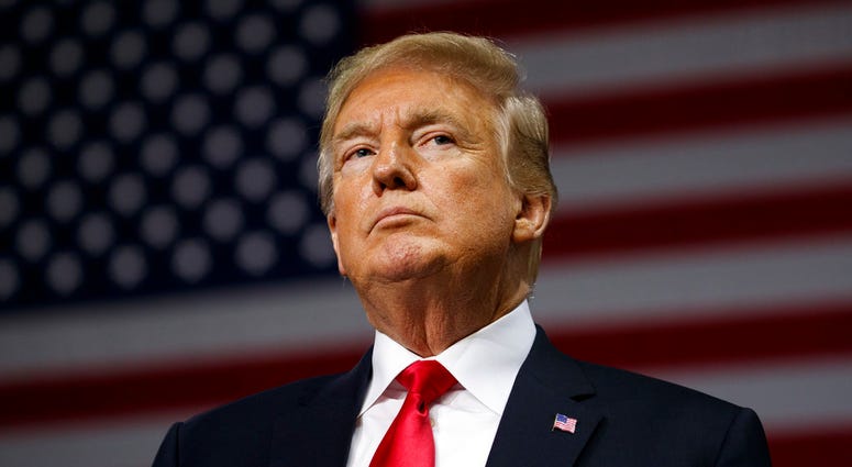 President Donald Trump listens during a campaign rally, Tuesday, July 31, 2018, in Tampa, Fla. (AP Photo/Evan Vucci)