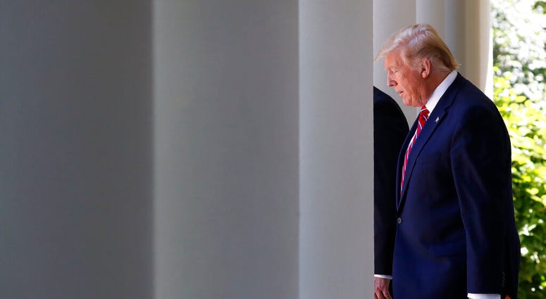 President Donald Trump walks through the Colonnade of the White House, next to Polish President Andrzej Duda, as they arrive for a news conference in the Rose Garden, Wednesday June 12, 2019, in Washington. (AP Photo/Jacquelyn Martin)