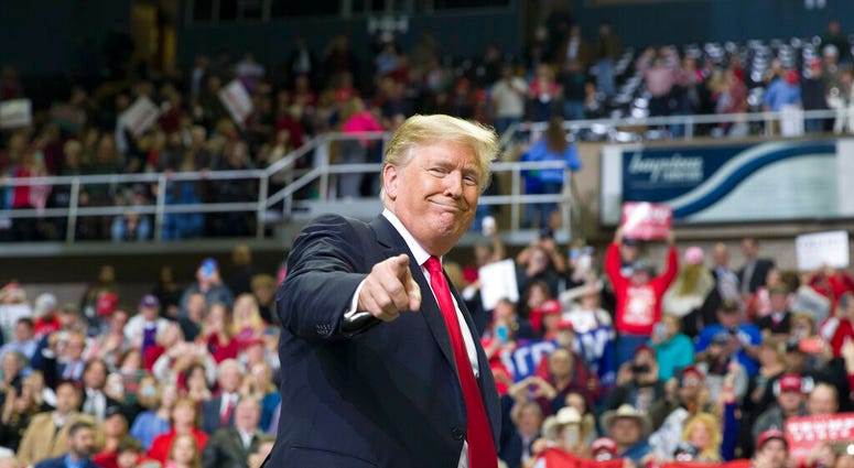 FILE - In this Nov. 26, 2018, file photo, President Donald Trump points to a supporter as he departs a rally at the Mississippi Coast Coliseum in Biloxi, Miss. President Donald Trump’s campaign has launched a state-by-state effort to prevent an intraparty