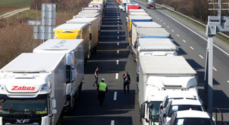 Trucks stand on the highway close to the border between Austria and Hungary near Bruck an der Leitha, Austria, Wednesday, March 18, 2020. (AP Photo/Ronald Zak) Trucks stand on the highway close to the border between Austria and Hungary near Bruck an der Leitha, Austria, Wednesday, March 18, 2020. (AP Photo/Ronald Zak)