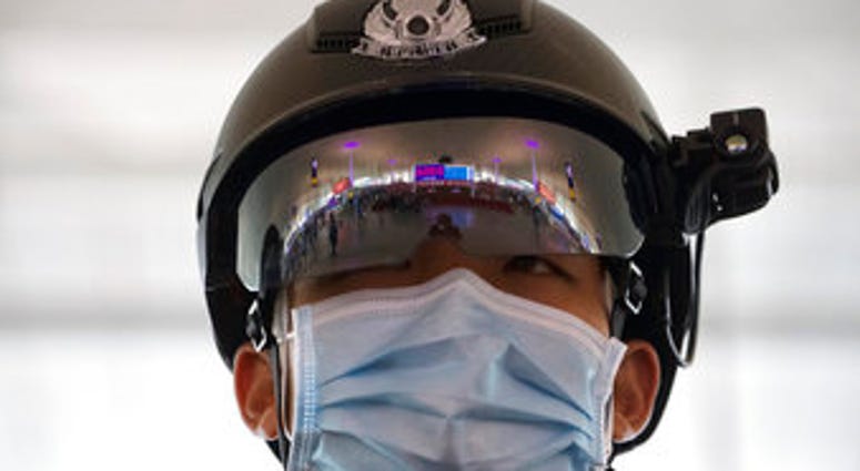A police officer wearing a face mask to protect against the spread of new coronavirus stands guard at Wuhan Tianhe International Airport in Wuhan in central China's Hubei Province. (AP Photo/Ng Han Guan) A police officer wearing a face mask to protect against the spread of new coronavirus stands guard at Wuhan Tianhe International Airport in Wuhan in central China's Hubei Province. (AP Photo/Ng Han Guan)