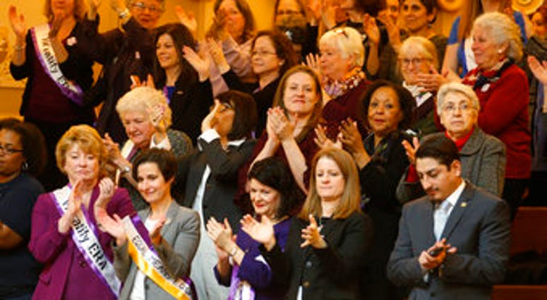 FILE - In this Thursday Feb. 21, 2019 file photo State Senators Janet Howell, D-Fairfax, front left and others applaud a speech along with other ERA supporters in the gallery of the the House of Delegates in Richmond, Va. (AP Photo/Steve Helber)