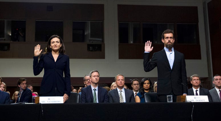 Facebook COO Sheryl Sandberg, left, accompanied by Twitter CEO Jack Dorsey are sworn in before the Senate Intelligence Committee on Capitol Hill, Wednesday, Sept. 5, 2018, in Washington. (AP Photo/Jose Luis Magana)
