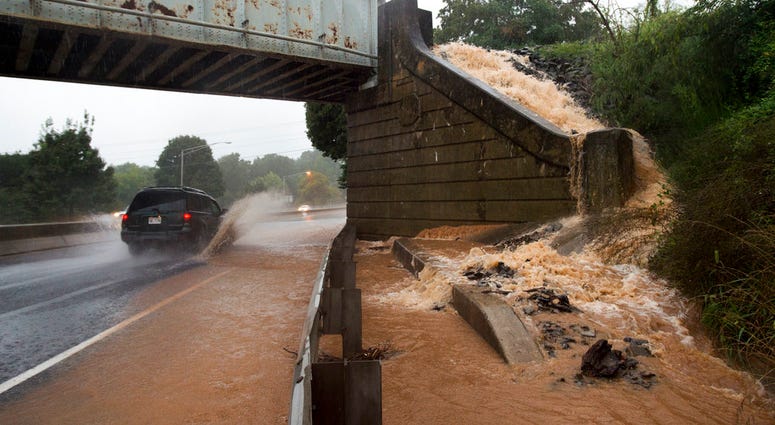 A vehicle drives through flooding during a thunderstorm Thursday Lynchburg. The National Weather Service said up to six inches of rain fell within hours, filling College Lake near Lynchburg beyond capacity. (Taylor Irby/The News & Advance via AP)