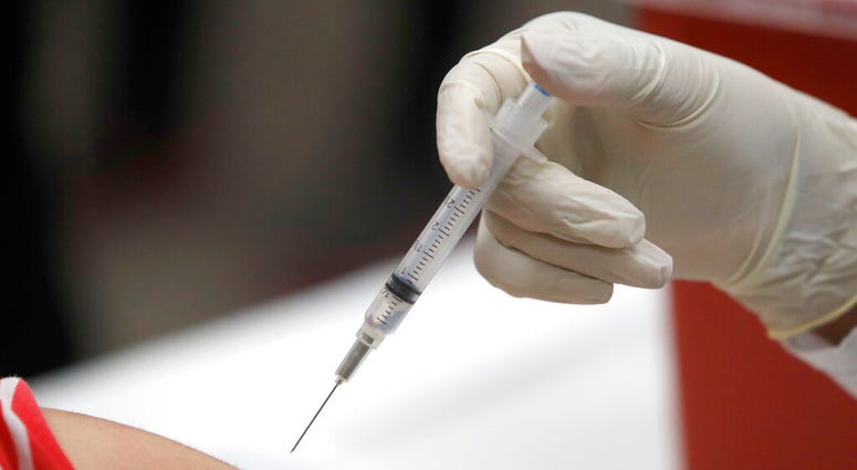 FILE - This Jan. 23, 2020 file photo shows a patient receiving a flu vaccination. (AP Photo/LM Otero, File) FILE - This Jan. 23, 2020 file photo shows a patient receiving a flu vaccination. (AP Photo/LM Otero, File)