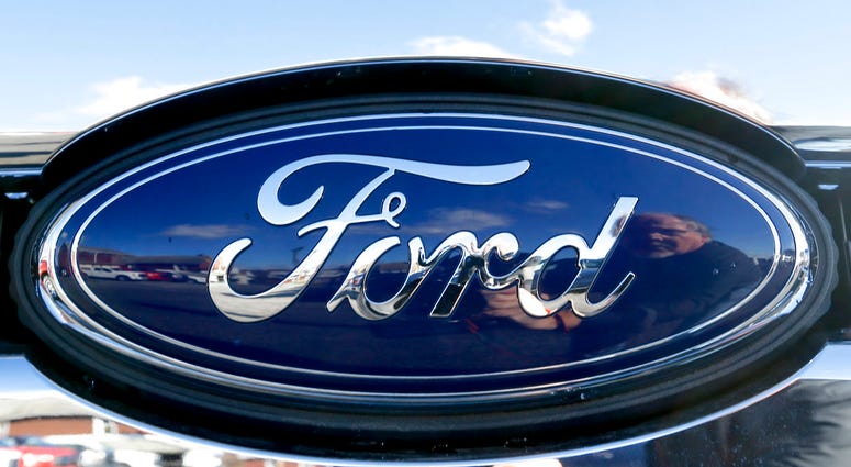 FILE - This Nov. 19, 2015 file photo shows the blue Ford oval badge in the grill of a pickup truck on a sales lot. (AP Photo/Keith Srakocic, File)