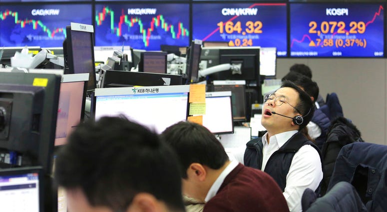 A currency trader shouts at the foreign exchange dealing room of the KEB Hana Bank headquarters in Seoul, South Korea, Thursday, Jan. 10, 2019. Asian markets were mostly lower Thursday. (AP Photo/Ahn Young-joon)