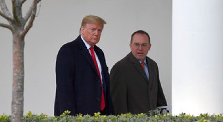 FILE - In this Jan. 13, 2020. file photo, President Donald Trump, left, and acting White House chief of staff Mick Mulvaney, right, walk along the colonnade of the White House in Washington. (AP Photo/Susan Walsh, File) FILE - In this Jan. 13, 2020. file photo, President Donald Trump, left, and acting White House chief of staff Mick Mulvaney, right, walk along the colonnade of the White House in Washington. (AP Photo/Susan Walsh, File)