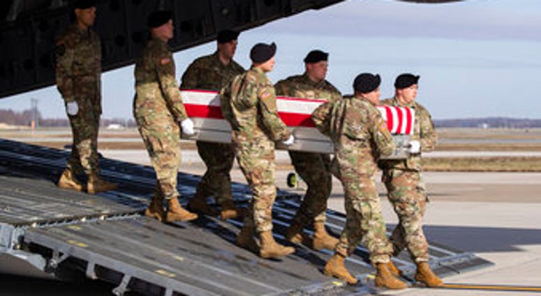 FILE - In this Dec. 25, 2019, file photo, an Army carry team moves a transfer case containing the remains of U.S. Army Sgt. 1st Class Michael Goble, at Dover Air Force Base, Del. (AP Photo/Alex Brandon, File) FILE - In this Dec. 25, 2019, file photo, an Army carry team moves a transfer case containing the remains of U.S. Army Sgt. 1st Class Michael Goble, at Dover Air Force Base, Del. (AP Photo/Alex Brandon, File)