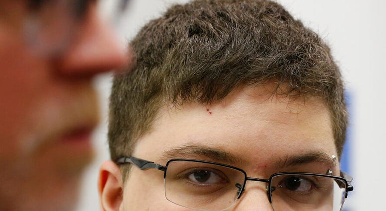 FILE - In this March 6, 2017, file photo, Gloucester County High School senior Gavin Grimm, a transgender student, listens to a speaker during a news conference in Richmond, Va. Grimm is continuing to sue the Gloucester County School Board in Virginia ove