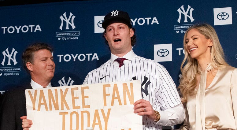 New York Yankees pitcher Gerrit Cole, center, holds a sign he used as a young Yankees fan, as he is introduced as the baseball clubs newest player during a baseball media availability, Wednesday, Dec. 18, 2019 in New York. (AP Photo/Mark Lennihan) New York Yankees pitcher Gerrit Cole, center, holds a sign he used as a young Yankees fan, as he is introduced as the baseball clubs newest player during a baseball media availability, Wednesday, Dec. 18, 2019 in New York. (AP Photo/Mark Lennihan)