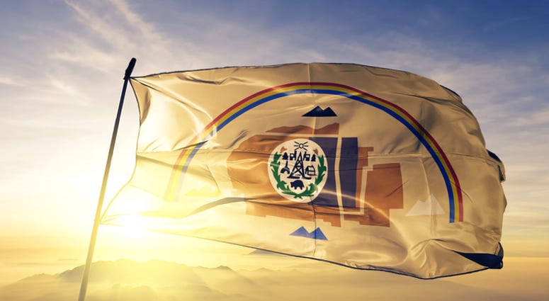 Navajo flag textile cloth fabric waving on the top sunrise mist fog