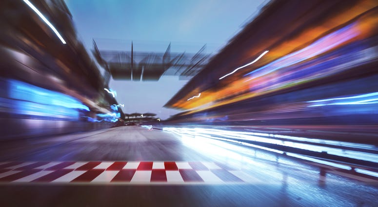 Motion blurred racetrack with start or end line and lighting effect apply .