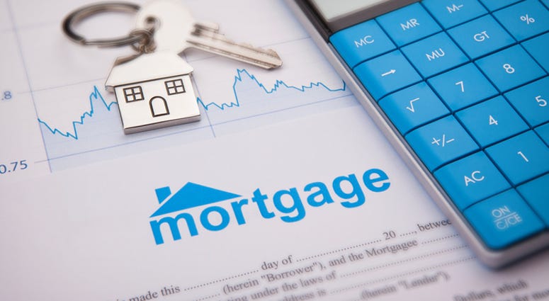 An empty mortgage application form with house key