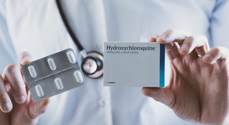 Doctor holding Hydroxychloroquine drug