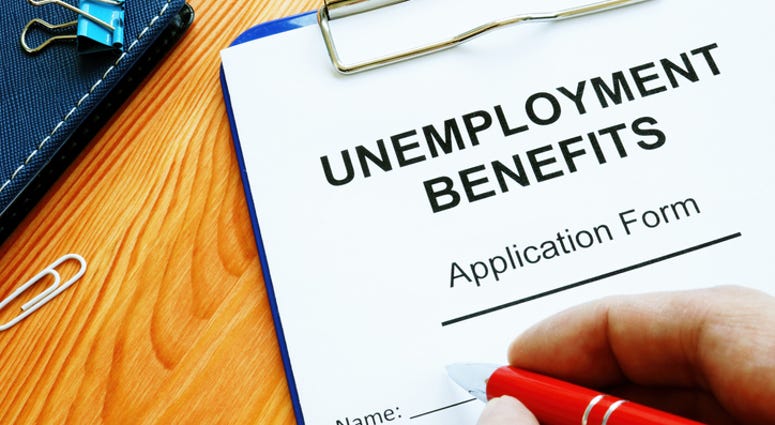 Man fills in Unemployment benefits application form.