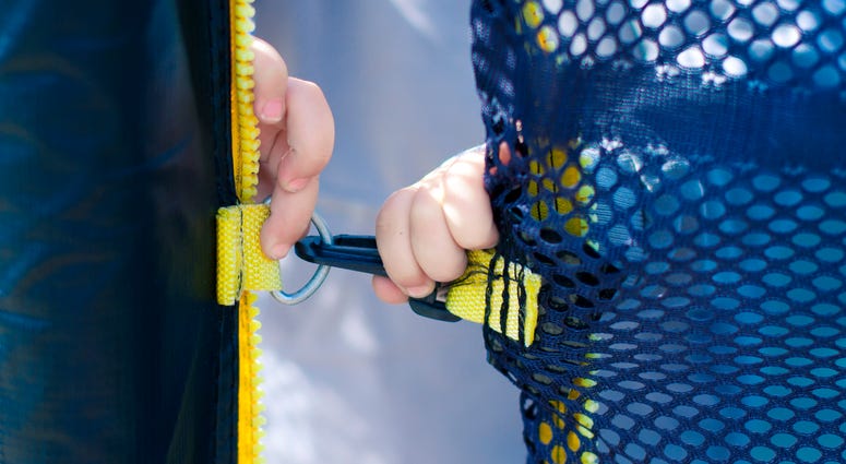 Child's hands trying to open the lock - stock photo