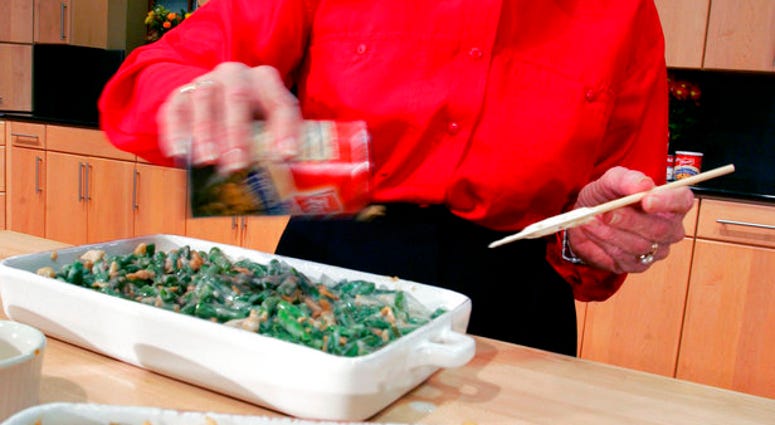 FILE - In this Nov. 15, 2005 file photo, a Green Bean Cassorole sits in the foreground as Dorcas Reilly prepares another at the Campbell Soup Co. corporate kitchen. (AP Photo/Mel Evans, File)