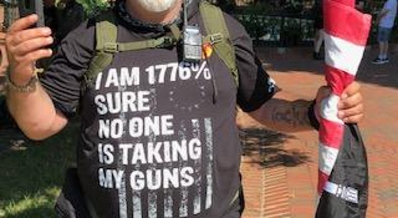 A gun rights activist marches at the State Capitol (Matt Demlein, News Radio WRVA)