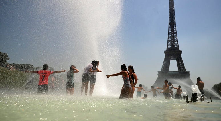 Youngsters cool off at the Trocadero public fountain in Paris, Wednesday, June 26, 2019. High temperatures are expected to go up to 39 degrees Celsius (102 Fahrenheit) in the Paris area later this week. (AP Photo/Francisco Seco)