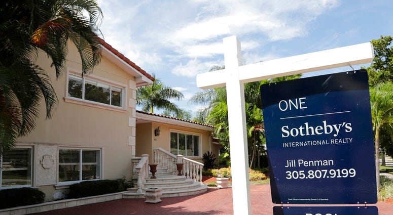 FILE - In this July 22, 2019 photo, a for sale sign is posted in front of a home in Miami. On Thursday, Aug. 8, Freddie Mac reports on this week’s average U.S. mortgage rates. (AP Photo/Lynne Sladky, File)