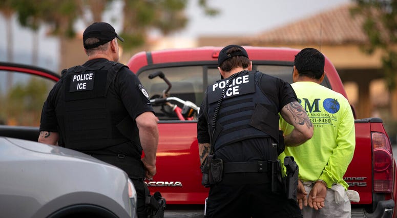 In this July 8, 2019, photo, a U.S. Immigration and Customs Enforcement (ICE) officers detain a man during an operation in Escondido, Calif. (AP Photo/Gregory Bull)