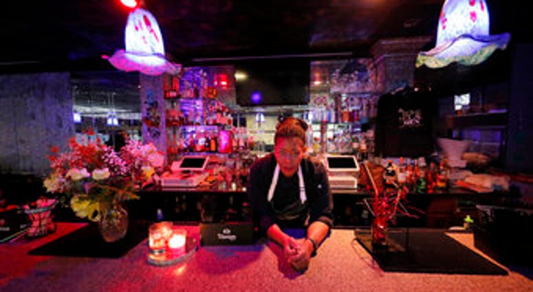 In this Tuesday, March 24, 2020, photo, Keisha Henry poses for a portrait inside her lounge and catering business in New Orleans. (AP Photo/Gerald Herbert) In this Tuesday, March 24, 2020, photo, Keisha Henry poses for a portrait inside her lounge and catering business in New Orleans. (AP Photo/Gerald Herbert)