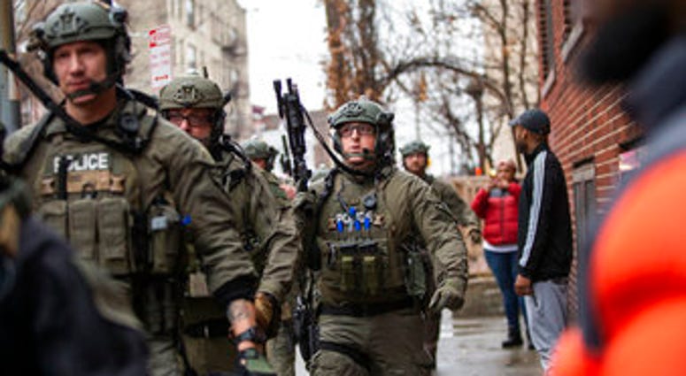 Police officers arrive at the scene following reports of gunfire, Tuesday, Dec. 10, 2019, in Jersey City, N.J. (AP Photo/Eduardo Munoz Alvarez) Police officers arrive at the scene following reports of gunfire, Tuesday, Dec. 10, 2019, in Jersey City, N.J. (AP Photo/Eduardo Munoz Alvarez)