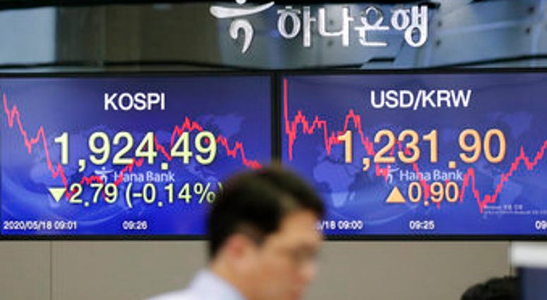 A currency trader walks near the screens showing the Korea Composite Stock Price Index (KOSPI), left, and the foreign exchange rate between U.S. dollar and South Korean won at the foreign exchange dealing room in Seoul, South Korea. (AP Photo/Lee Jin-man) A currency trader walks near the screens showing the Korea Composite Stock Price Index (KOSPI), left, and the foreign exchange rate between U.S. dollar and South Korean won at the foreign exchange dealing room in Seoul, South Korea. (AP Photo/Lee Jin-man)