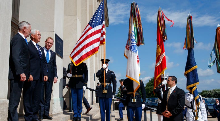 Vice President Mike Pence, center, is greeted by Deputy Secretary of Defense Pat Shanahan, right, and Secretary of Defense Jim Mattis before announcing the creation of a United States Space Force, Aug. 9, 2018, at the Pentagon. (AP Photo/Evan Vucci)