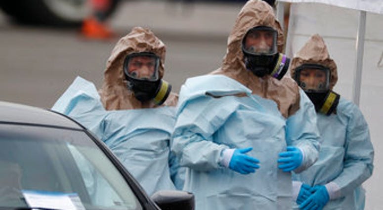 Colorado National Guard medical personnel prepare to perform coronavirus test on a motorist at a drive-thru testing site outside the Denver Coliseum Saturday, March 14, 2020, in Denver. (AP Photo/David Zalubowski) Colorado National Guard medical personnel prepare to perform coronavirus test on a motorist at a drive-thru testing site outside the Denver Coliseum Saturday, March 14, 2020, in Denver. (AP Photo/David Zalubowski)