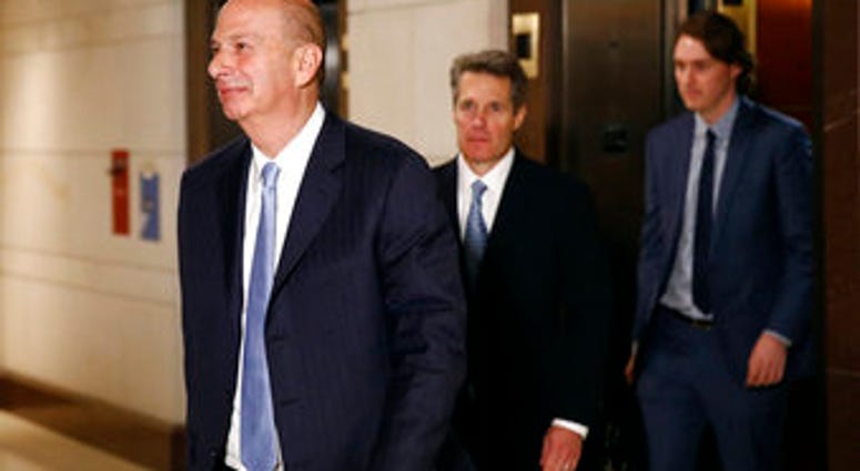 US Ambassador to the European Union Gordon Sondland, left, walks to a secure area of the Capitol to testify as part of the House impeachment inquiry into President Donald Trump, Monday, Oct. 28, 2019, in Washington. (AP Photo/Patrick Semansky)