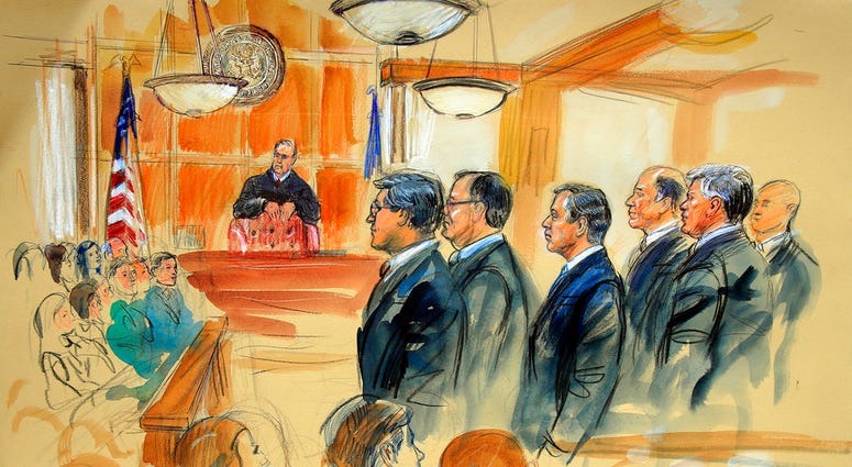 This courtroom sketch depicts Paul Manafort, fourth from right, standing with his lawyers in front of U.S. district Judge T.S. Ellis III, center rear, and the selected jury, seated left, during the jury selection of his trial at the Alexandria Federal Cou