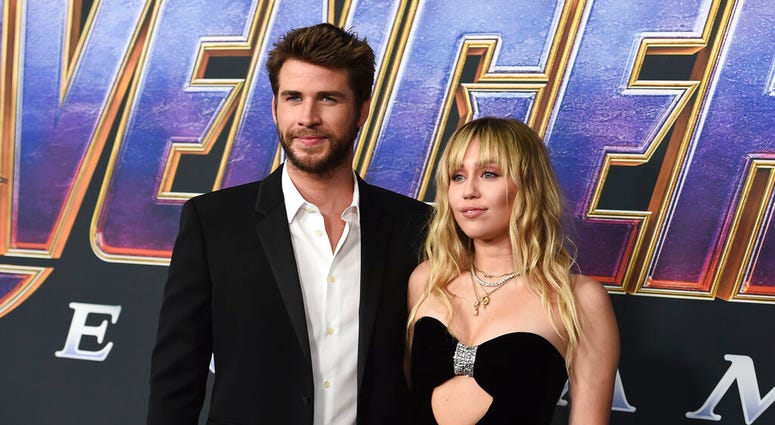FILE - In this Monday, April 22, 2019, file photo, Liam Hemsworth, left, and Miley Cyrus arrive at the premiere of "Avengers: Endgame" at the Los Angeles Convention Center. (Photo by Jordan Strauss/Invision/AP, File)