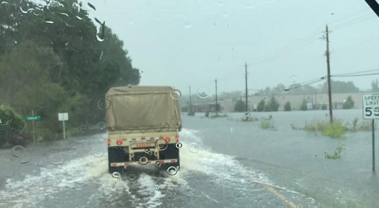 Virginia National Guard Soldiers assigned to the Virginia Beach-based 1173rd Transportation Company drive through high water to deliver supplies to shelters Sept. 17, 2018, in North Carolina. (Virginia Guard Public Affairs)