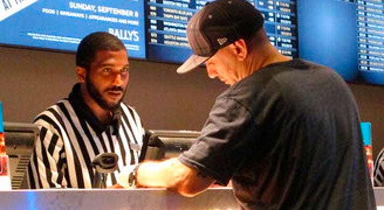 FILE - In this Sept. 5, 2019, file photo, a gambler making a sports bet at Bally's casino in Atlantic City, N.J. (AP Photo/Wayne Parry, File) FILE - In this Sept. 5, 2019, file photo, a gambler making a sports bet at Bally's casino in Atlantic City, N.J. (AP Photo/Wayne Parry, File)