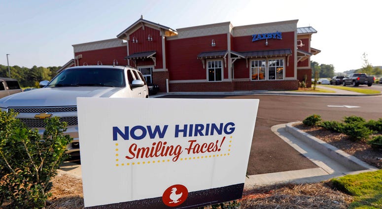 This July 25, 2018, photo shows a help wanted sign at a new Zaxby's restaurant in Madison, Miss. On Friday, Sept. 7, the Labor Department reports on job openings and labor turnover for August. (AP Photo/Rogelio V. Solis)