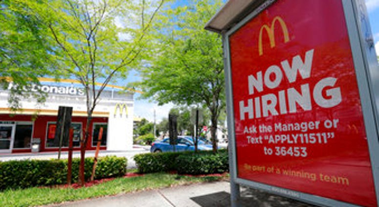 FILE - In this July 1, 2019, file photo, a help wanted sign appears on a bus stop in front of a McDonald's restaurant in Miami. (AP Photo/Wilfredo Lee, File) FILE - In this July 1, 2019, file photo, a help wanted sign appears on a bus stop in front of a McDonald's restaurant in Miami. (AP Photo/Wilfredo Lee, File)