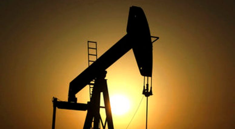 FILE- In this Wednesday, June 8, 2011 file photo, sun sets behind an oil pump in the desert oil fields of Sakhir, Bahrain. The global benchmark for crude oil rose above $70 a barrel on Monday. (AP Photo/Hasan Jamali, File) FILE- In this Wednesday, June 8, 2011 file photo, sun sets behind an oil pump in the desert oil fields of Sakhir, Bahrain. The global benchmark for crude oil rose above $70 a barrel on Monday. (AP Photo/Hasan Jamali, File)