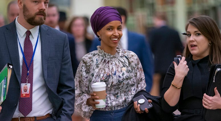 Rep. Ilhan Omar, D-Minn., walks at the Capitol as top House Democrats plan to offer a measure that condemns anti-Semitism in the wake of controversial remarks by the freshman congresswoman, in Washington, March 6, 2019. (AP Photo/J. Scott Applewhite)