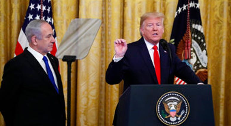 President Donald Trump, joined by Israeli Prime Minister Benjamin Netanyahu, speaks during an event in the East Room of the White House in Washington, Tuesday, Jan. 28, 2020. (AP Photo/Alex Brandon) President Donald Trump, joined by Israeli Prime Minister Benjamin Netanyahu, speaks during an event in the East Room of the White House in Washington, Tuesday, Jan. 28, 2020. (AP Photo/Alex Brandon)