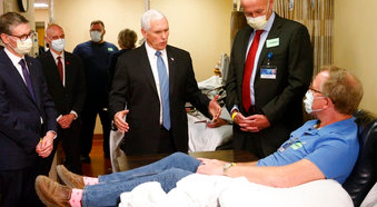 Vice President Mike Pence, center, visits Dennis Nelson, a patient who survived the coronavirus and was going to give blood, during a tour of the Mayo Clinic Tuesday, April 28, 2020. (AP Photo/Jim Mone) Vice President Mike Pence, center, visits Dennis Nelson, a patient who survived the coronavirus and was going to give blood, during a tour of the Mayo Clinic Tuesday, April 28, 2020. (AP Photo/Jim Mone)