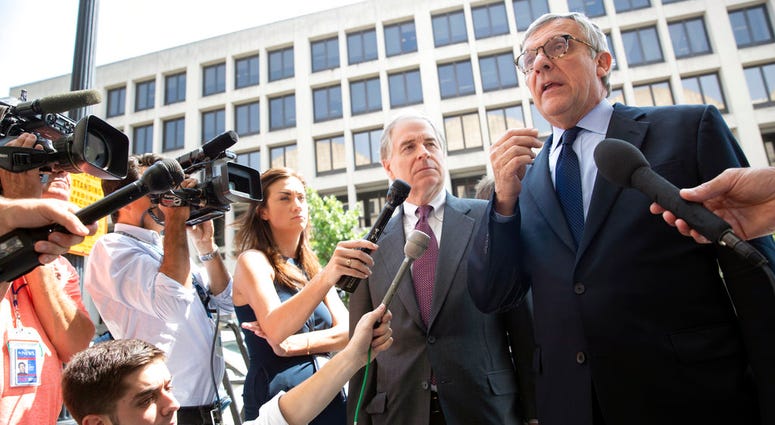 Paul Kamenar, right, attorney for Andrew Miller, joined by Peter Flaherty, center, chairman of the National Legal and Policy Center, talks to reporters after a federal judge found Miller in contempt for refusing to testify before the grand jury hearing ev