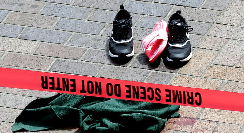 Clothing is strewn on the sidewalk at a scene where pedestrians were hit by a motorist in Portland, Ore., Friday, May 25, 2018. Police say three women have been injured in a hit-and-run crash near Portland State University.