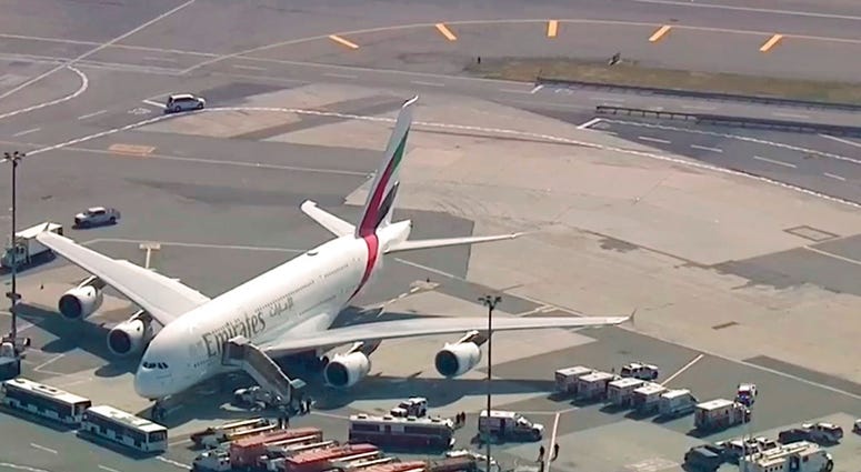 In this frame from video emergency response crews gather outside a plane at JFK Airport amid reports of ill passengers aboard a flight from Dubai on Wednesday, Sept. 5, 2018, in New York. (WABC 7 via AP)