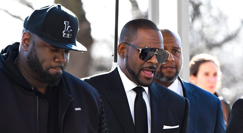 R. Kelly, right, arrives at the Leighton Criminal Court for a hearing on Friday, March 22, 2019, in Chicago. (AP Photo/Matt Marton)